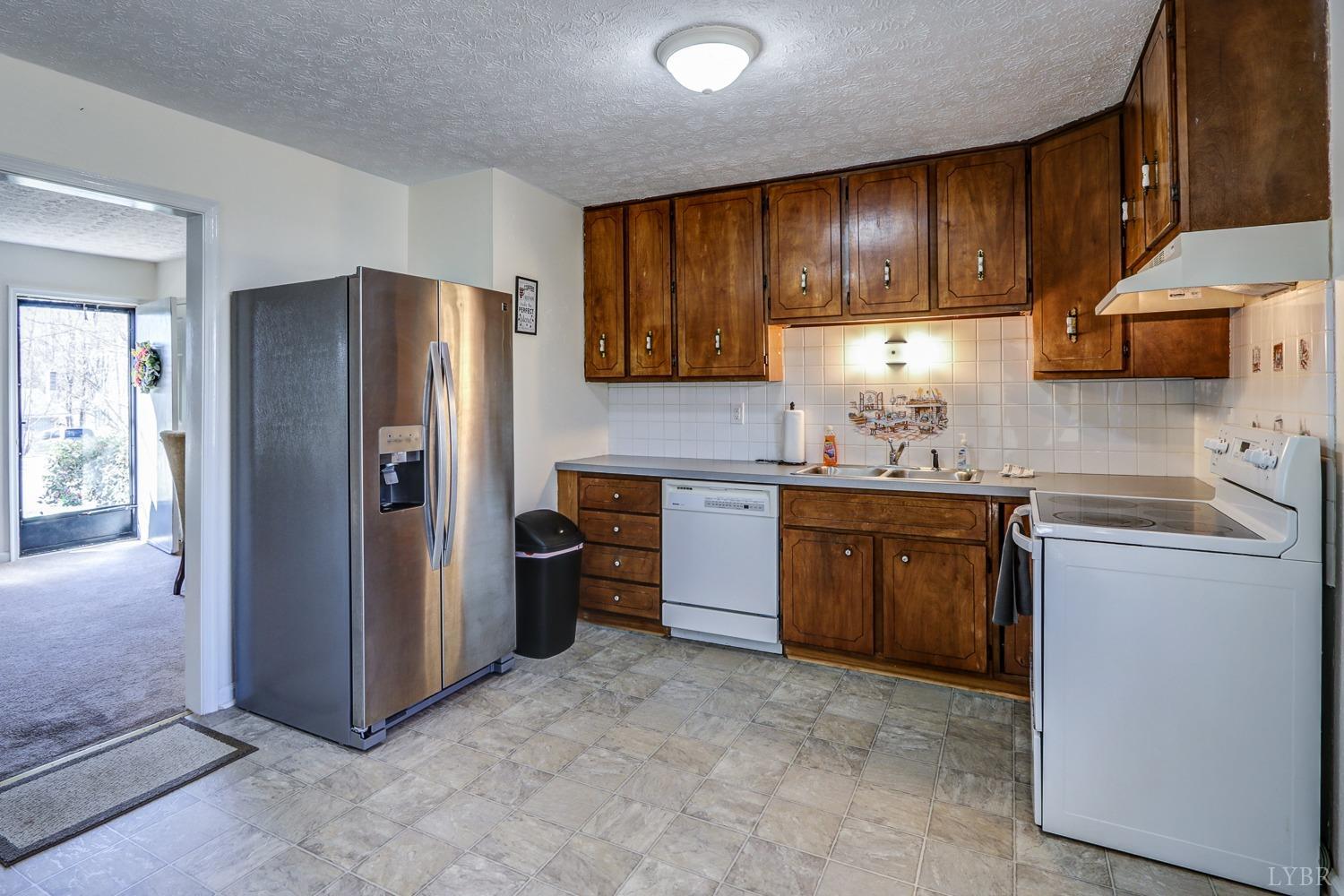 721 Doss Road Concord, VA 24538 - Photo 17 of 35 a kitchen with stainless steel appliances granite countertop a refrigerator stove and sink