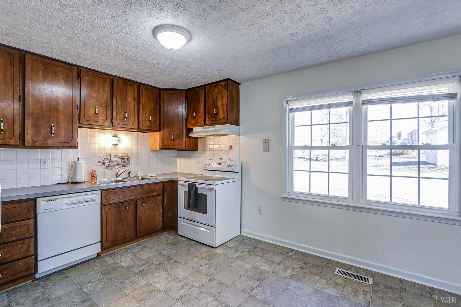 721 Doss Road Concord, VA 24538 - Photo 18 of 35 a kitchen with stainless steel appliances granite countertop a stove sink and cabinets