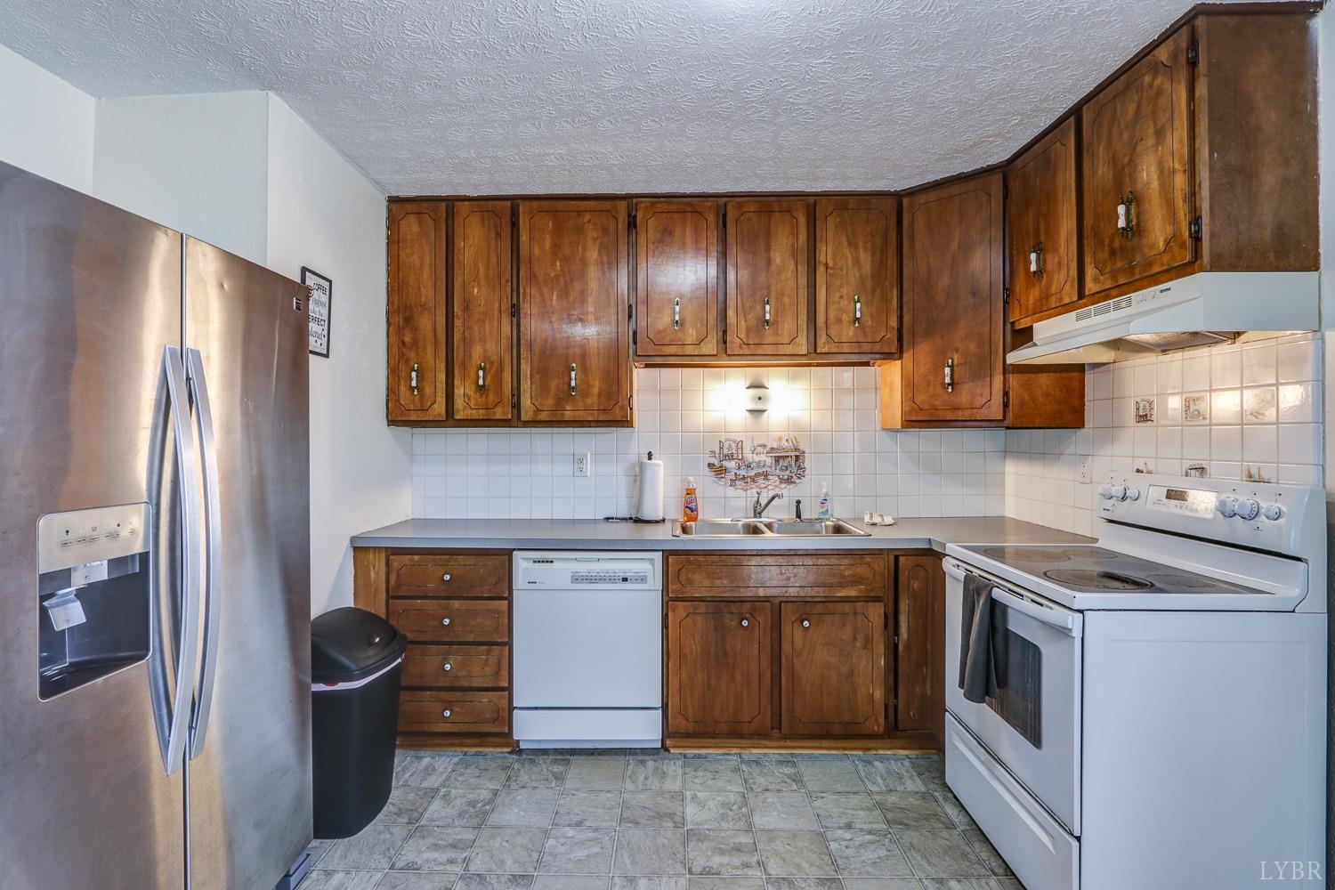 721 Doss Road Concord, VA 24538 - Photo 19 of 35 a kitchen with stainless steel appliances granite countertop a refrigerator and a stove top oven