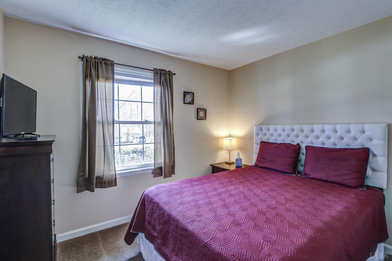 721 Doss Road Concord, VA 24538 - Photo 23 of 35 a bedroom with a bed and a flat tv screen on dresser
