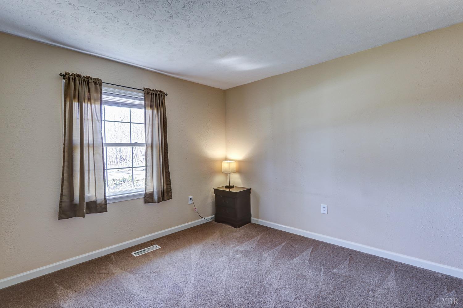 721 Doss Road Concord, VA 24538 - Photo 27 of 35 a view of an empty room with window and fire place