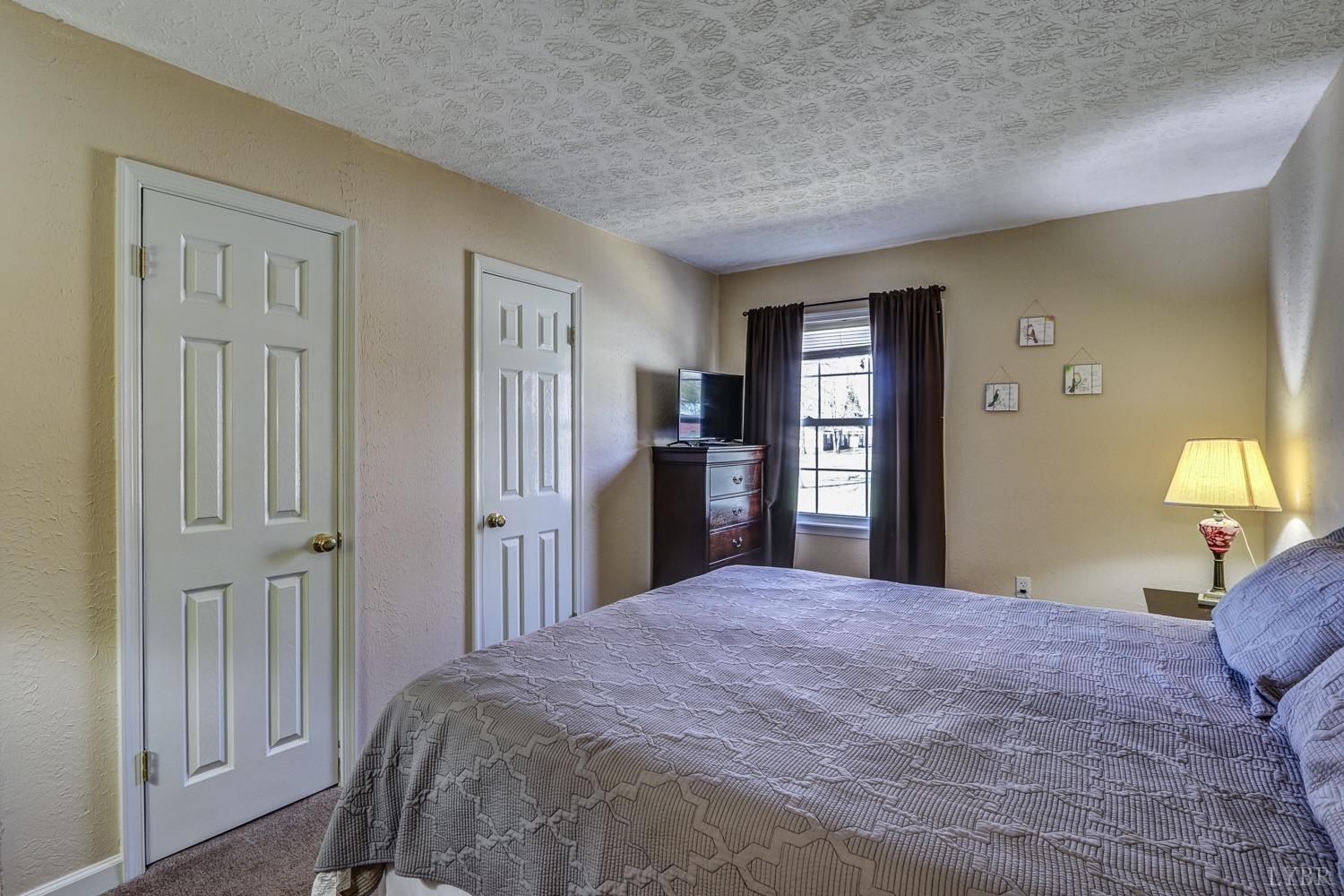 721 Doss Road Concord, VA 24538 - Photo 30 of 35 a bedroom with a large bed and dresser