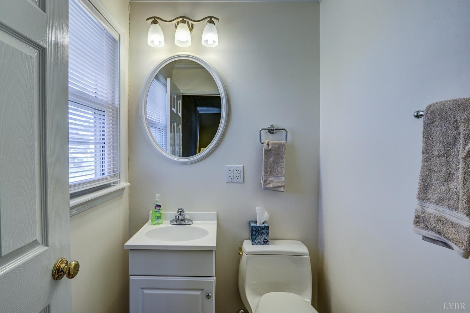 721 Doss Road Concord, VA 24538 - Photo 32 of 35 a bathroom with a toilet sink vanity and mirror