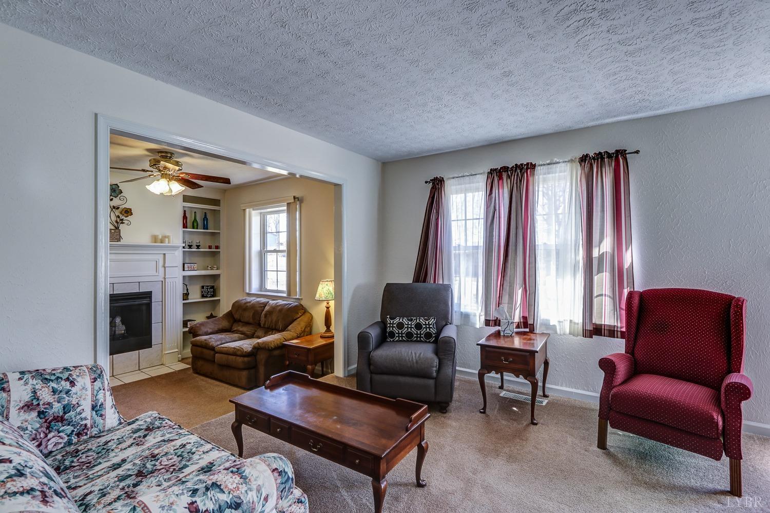 721 Doss Road Concord, VA 24538 - Photo 6 of 35 a living room with furniture fireplace and a large window