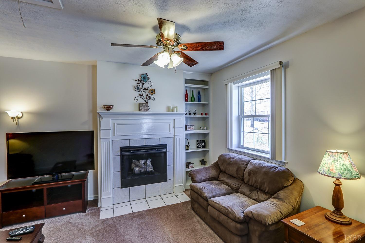 721 Doss Road Concord, VA 24538 - Photo 10 of 35 a living room with furniture a flat screen tv and a fireplace