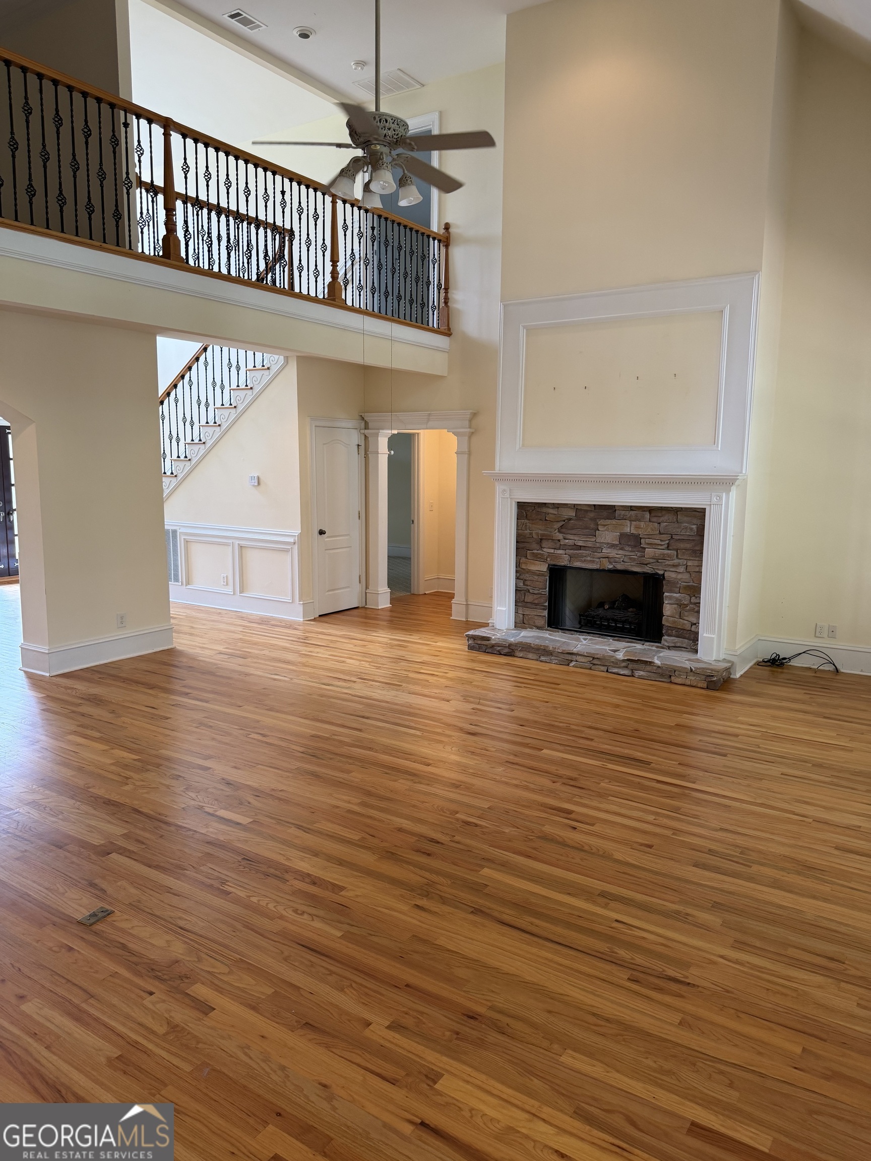 302 Norris Road Barnesville, GA 30204 - Photo 20 of 65 an empty room with wooden floor a fireplace and windows