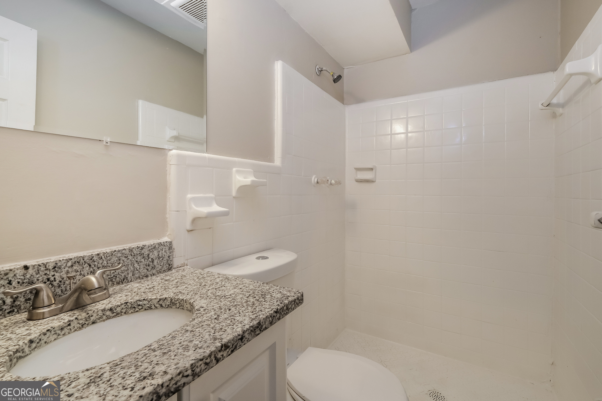 3660 Sterling Ridge Way Decatur, GA 30032 - Photo 19 of 23 a bathroom with a granite countertop sink toilet and shower
