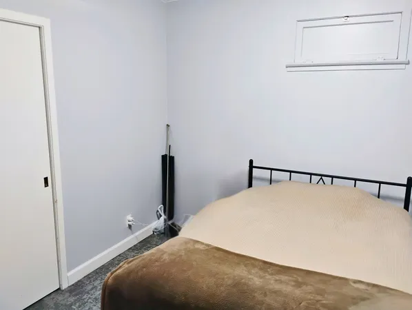 a bed room with a bed and a window
