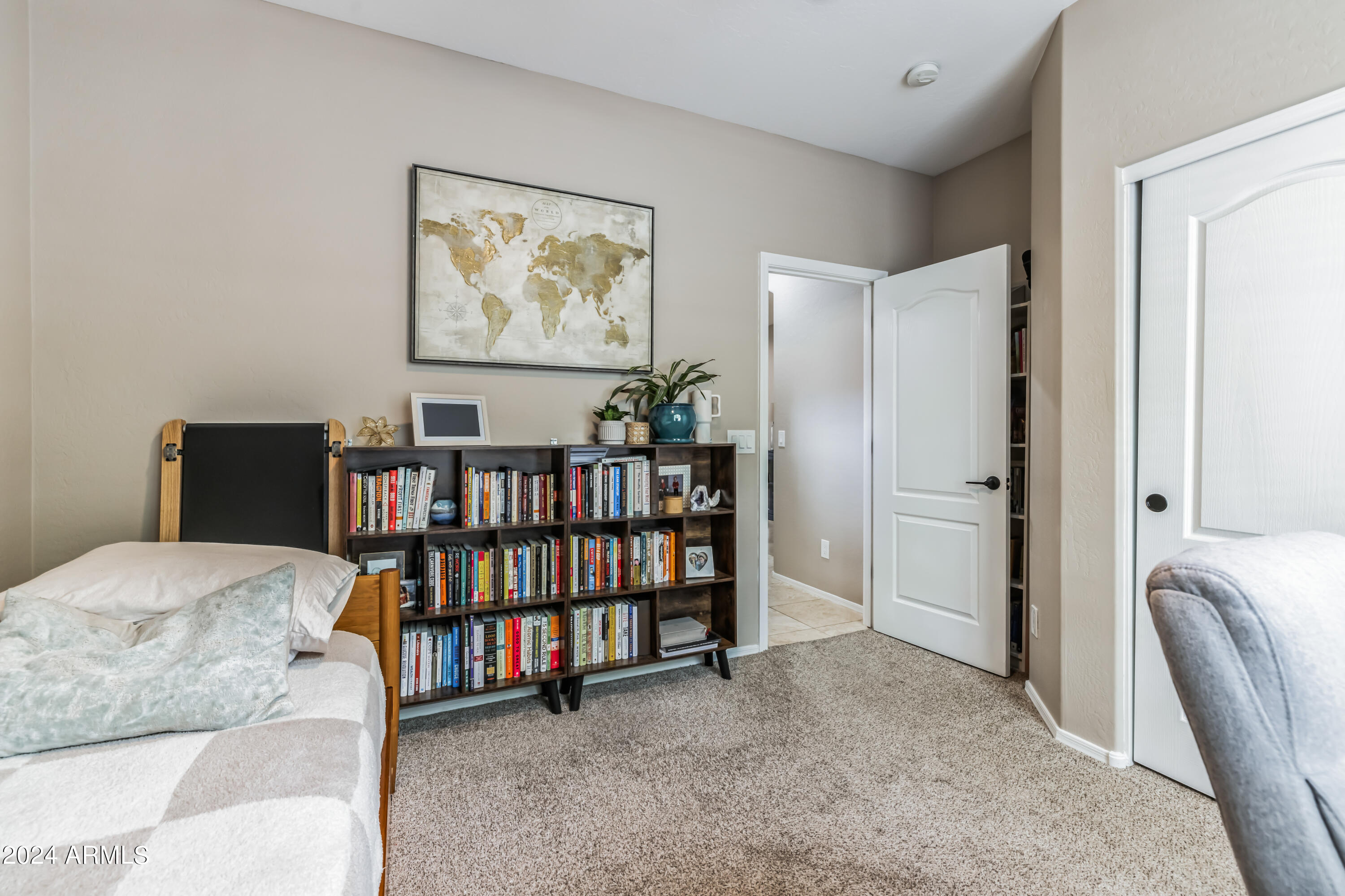 2535 South Martingale Road Gilbert, AZ 85295 - Photo 16 of 25 a bedroom with furniture and a book shelf