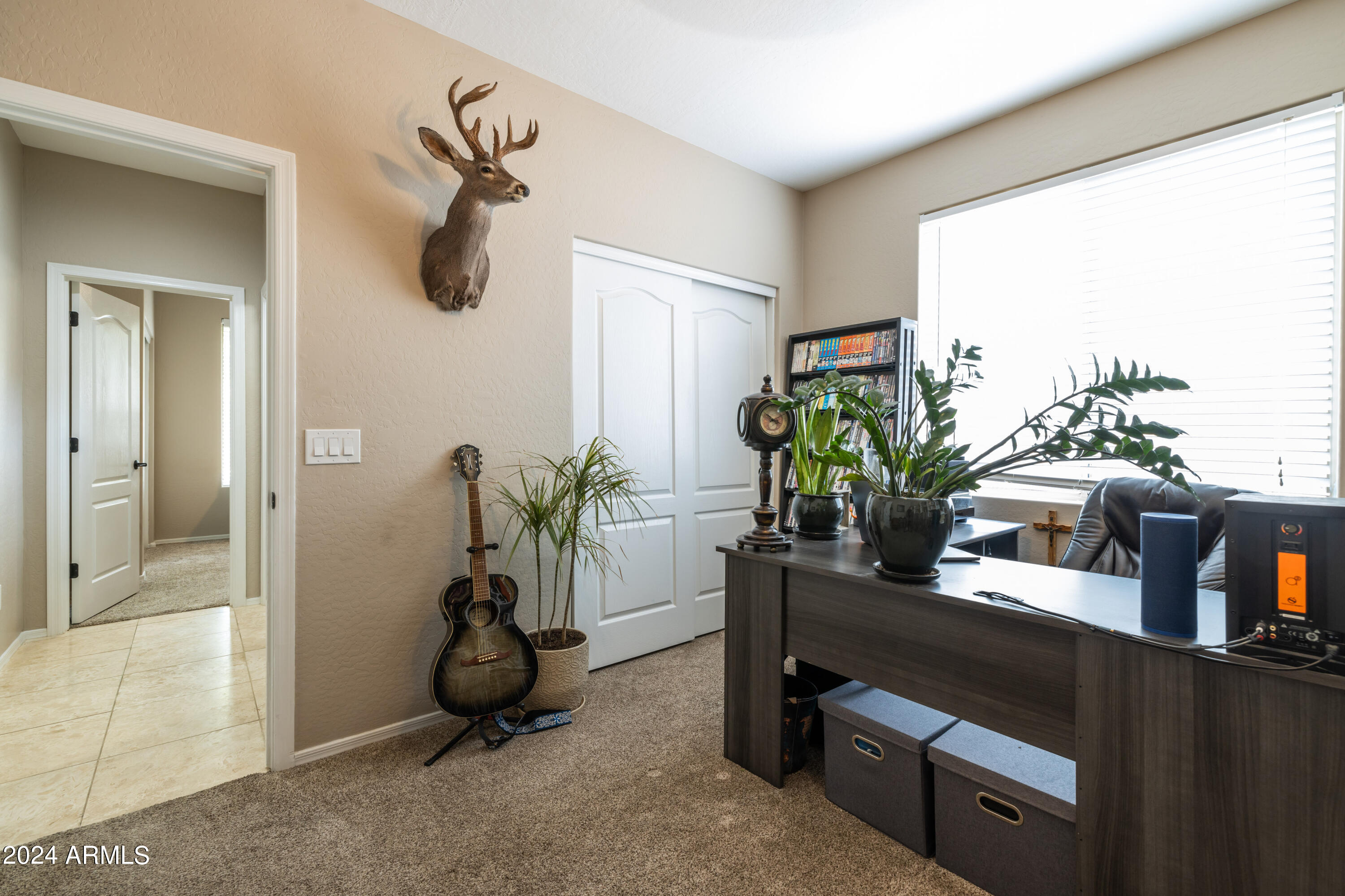 2535 South Martingale Road Gilbert, AZ 85295 - Photo 18 of 25 a view of a workspace with furniture and a potted plant