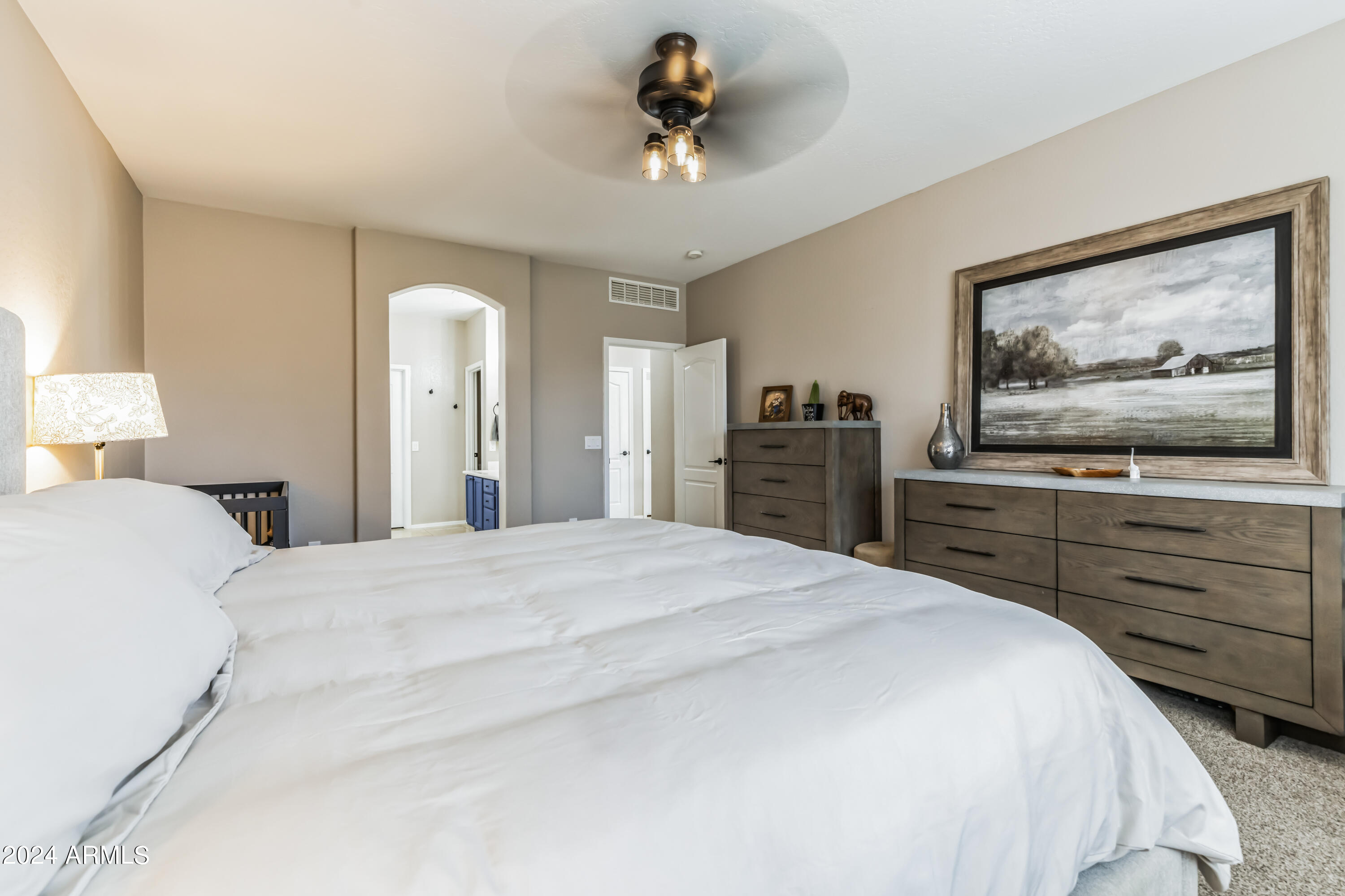 2535 South Martingale Road Gilbert, AZ 85295 - Photo 10 of 25 a bedroom with a bed and a chandelier