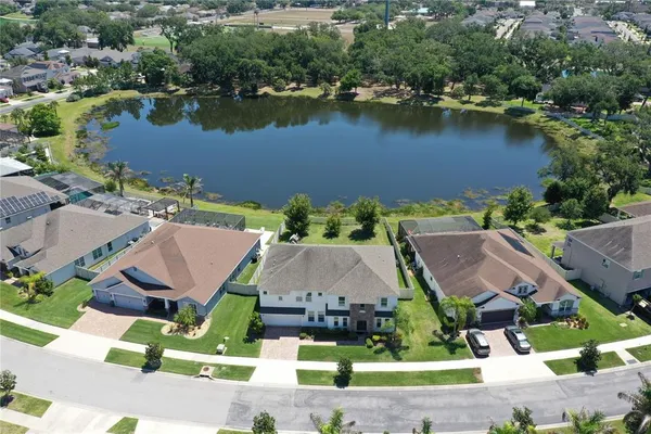 an aerial view of a house with outdoor space and lake view