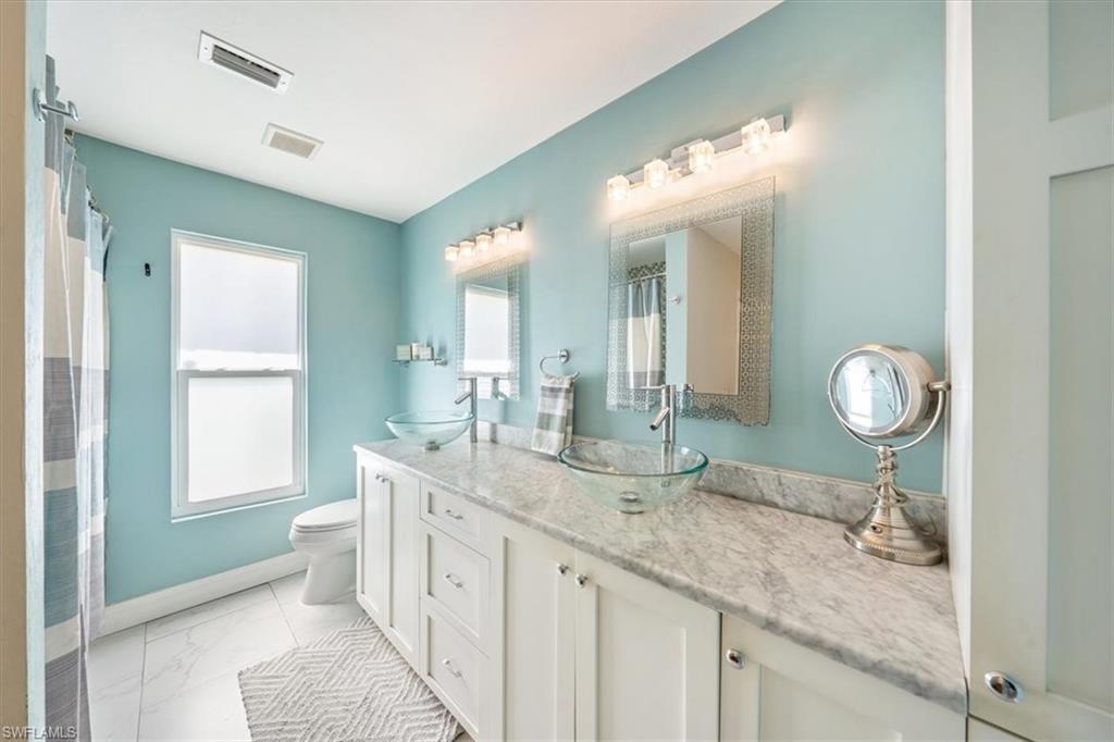 463 Torrey Pines Point Naples, FL 34113 - Photo 11 of 24 a bathroom with a granite countertop sink and a mirror