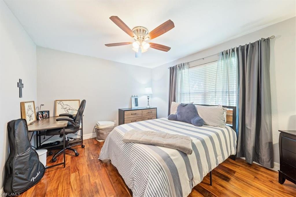 463 Torrey Pines Point Naples, FL 34113 - Photo 12 of 24 a bed room with a bed and a ceiling fan