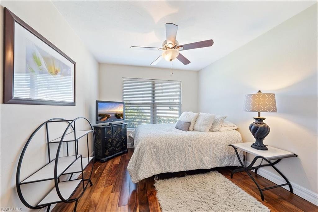 463 Torrey Pines Point Naples, FL 34113 - Photo 15 of 24 a bedroom with a bed a dresser and chair