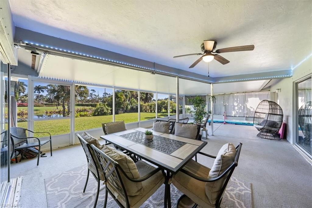 463 Torrey Pines Point Naples, FL 34113 - Photo 16 of 24 a view of a dining room with furniture large windows and a chandelier