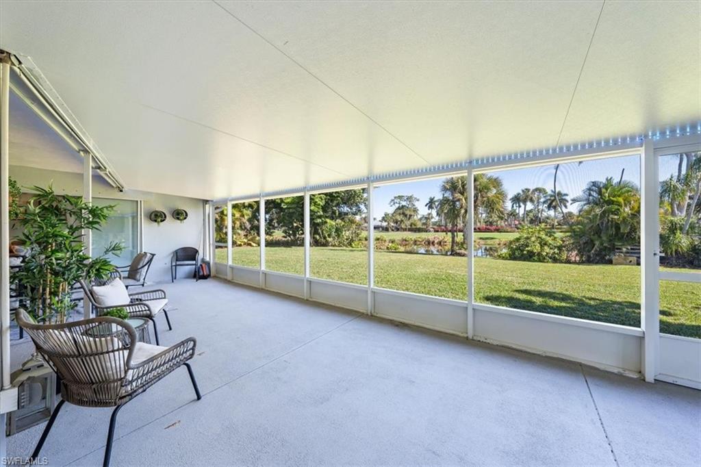 463 Torrey Pines Point Naples, FL 34113 - Photo 17 of 24 a view of a porch with furniture and floor to ceiling window