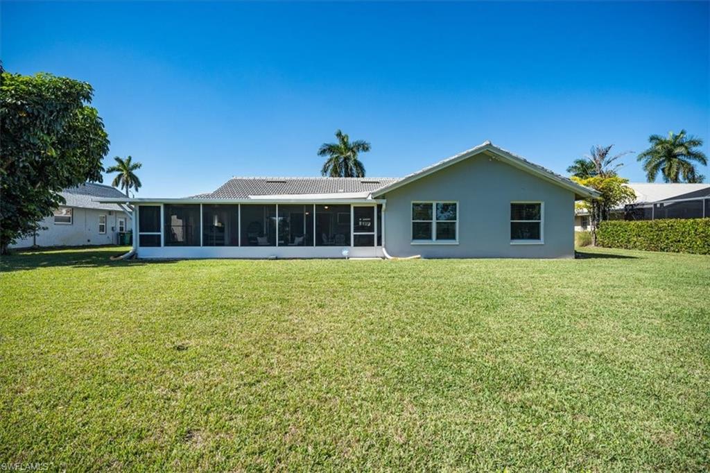 463 Torrey Pines Point Naples, FL 34113 - Photo 19 of 24 a front view of a house with a garden