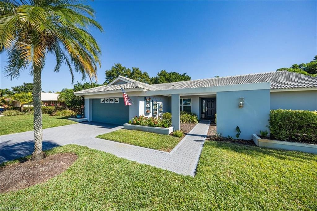 463 Torrey Pines Point Naples, FL 34113 - Photo 2 of 24 a view of a house with a yard and potted plants