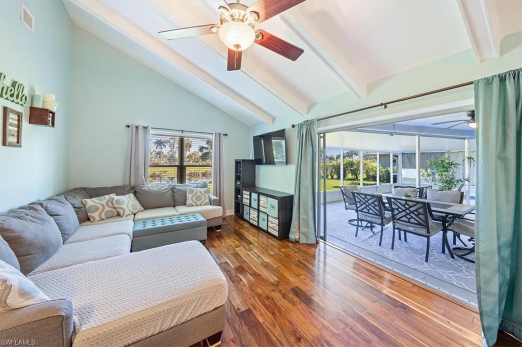 463 Torrey Pines Point Naples, FL 34113 - Photo 21 of 24 a living room with furniture and a wooden floor