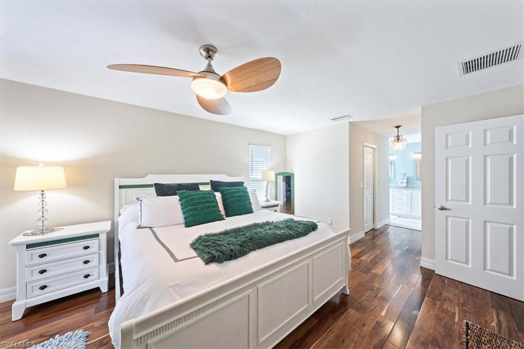463 Torrey Pines Point Naples, FL 34113 - Photo 24 of 24 a bedroom with a bed and wooden floor