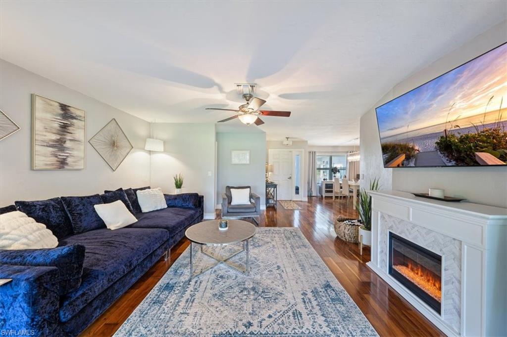 463 Torrey Pines Point Naples, FL 34113 - Photo 4 of 24 a living room with furniture and a fireplace