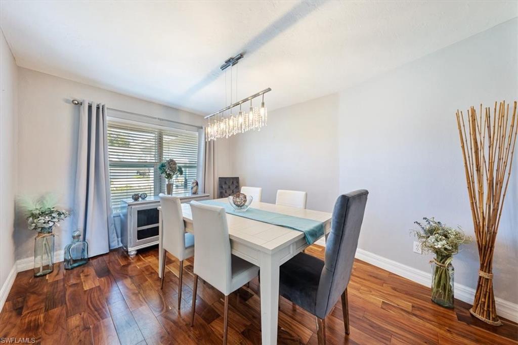463 Torrey Pines Point Naples, FL 34113 - Photo 7 of 24 a view of a dining room with furniture window and wooden floor