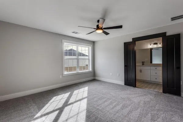 a view of a livingroom with a ceiling fan and window