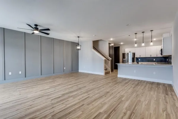 a view of a kitchen with a sink and a large window
