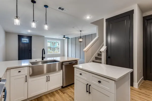 a kitchen with white cabinets and white appliances