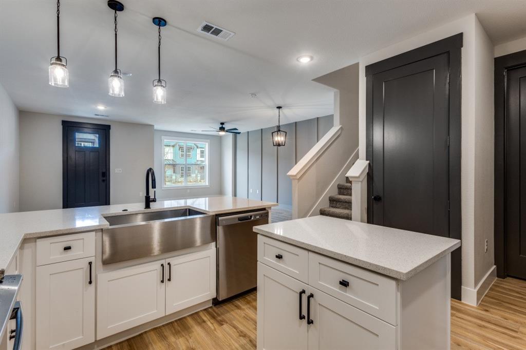 1752 Palladio Loop Princeton, TX 75407 - Photo 3 of 18 a kitchen with white cabinets and white appliances