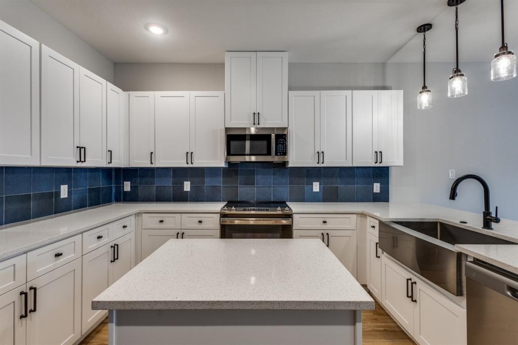 1752 Palladio Loop Princeton, TX 75407 - Photo 5 of 18 a kitchen with granite countertop white cabinets and stainless steel appliances
