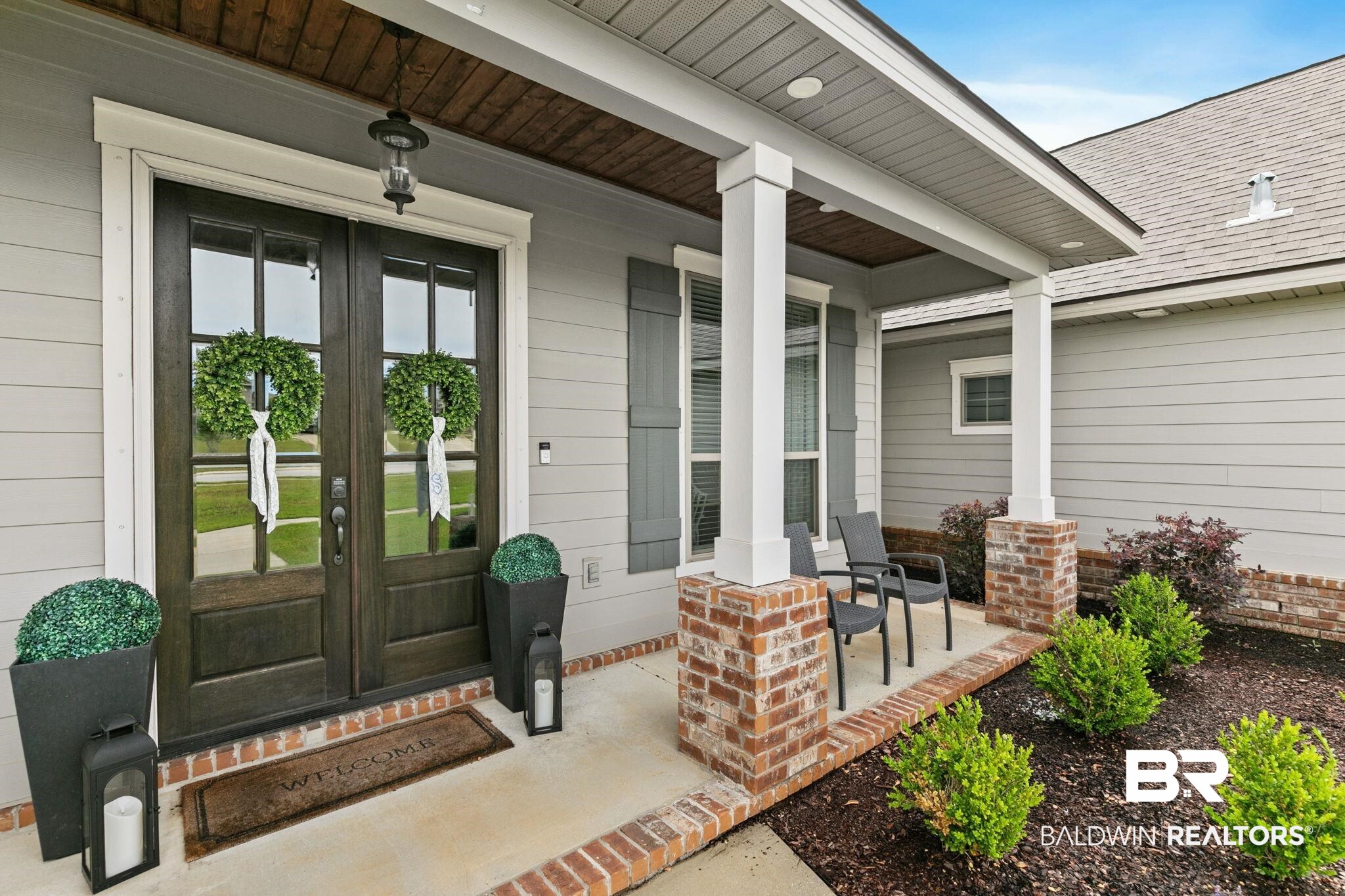 13233 Ibis Boulevard Daphne, AL 36527 - Photo 3 of 100 Covered front porch featuring brick columns and dark wood double entry doors with glass panels