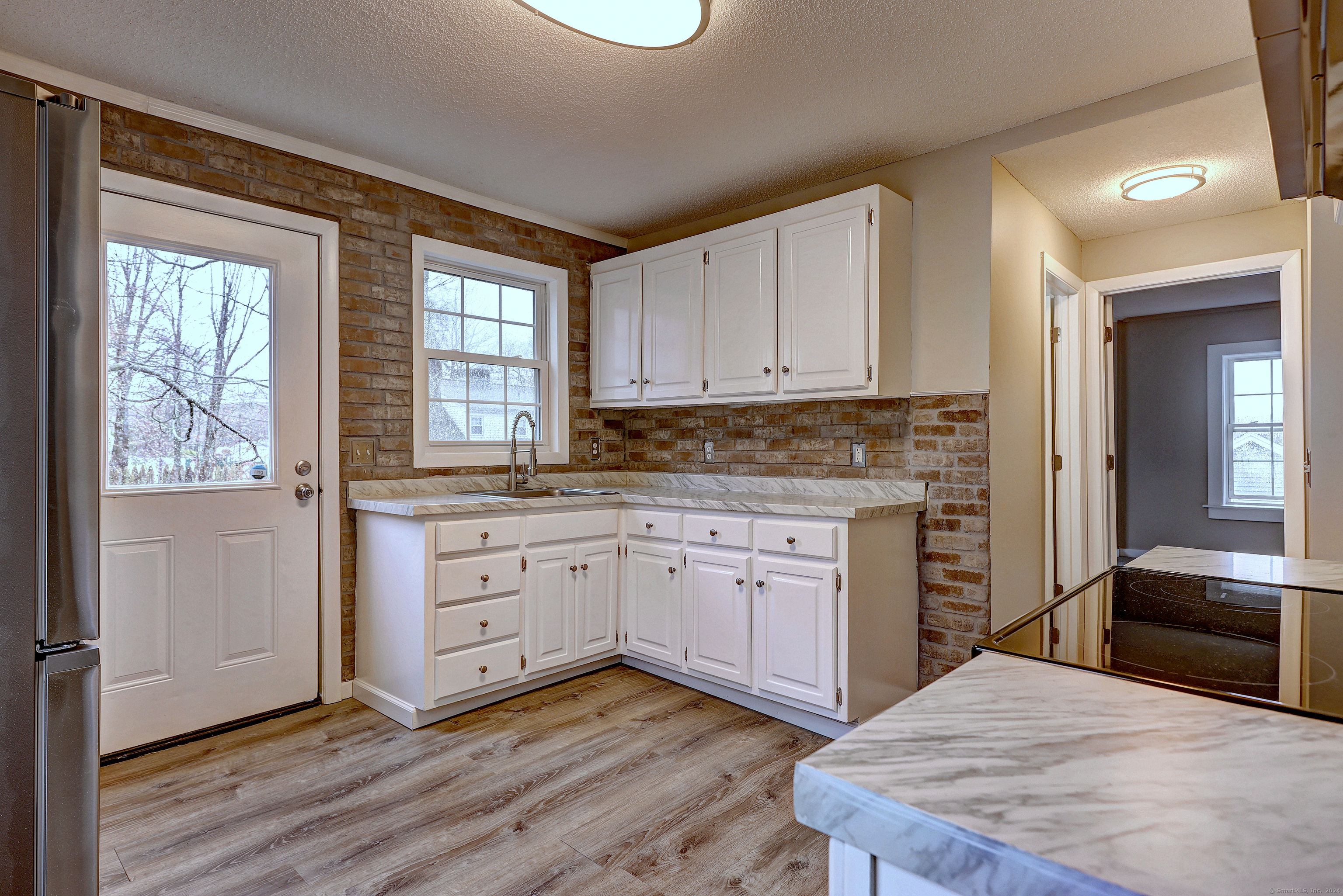 a kitchen with stainless steel appliances granite countertop a stove a sink and a refrigerator