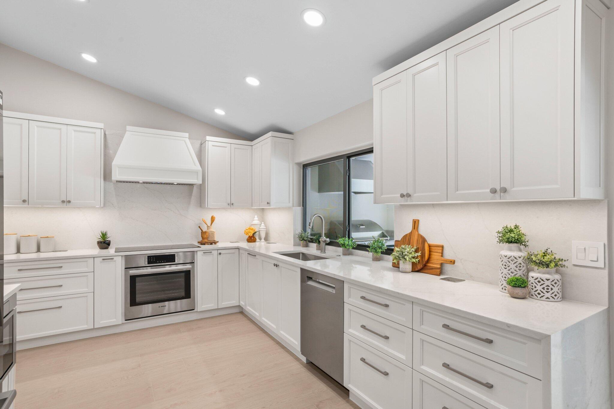 3901 Northwest 27th Avenue Boca Raton, FL 33434 - Photo 21 of 56 a kitchen with stainless steel appliances white cabinets and a sink