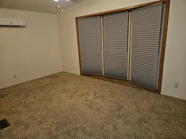 a view of an empty room with a wooden floor