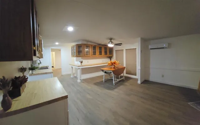 a large white kitchen with cabinets