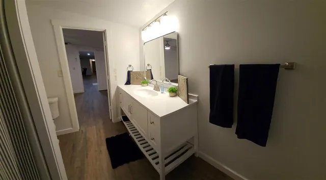 a view of a room with wooden floor