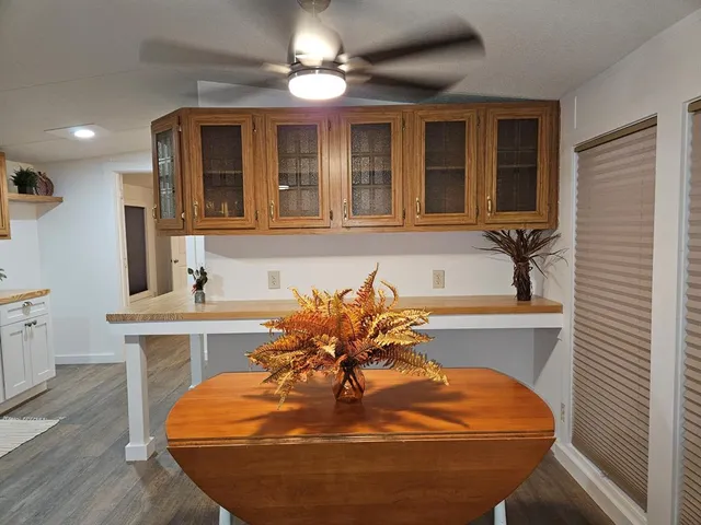 a view of a dining room with furniture and chandelier