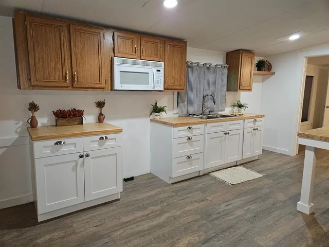 a kitchen with sink cabinets and wooden floor