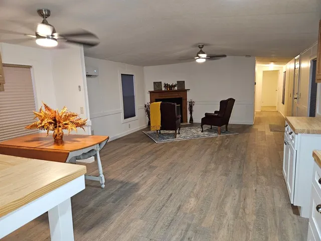 a living room with furniture a fireplace and a chandelier