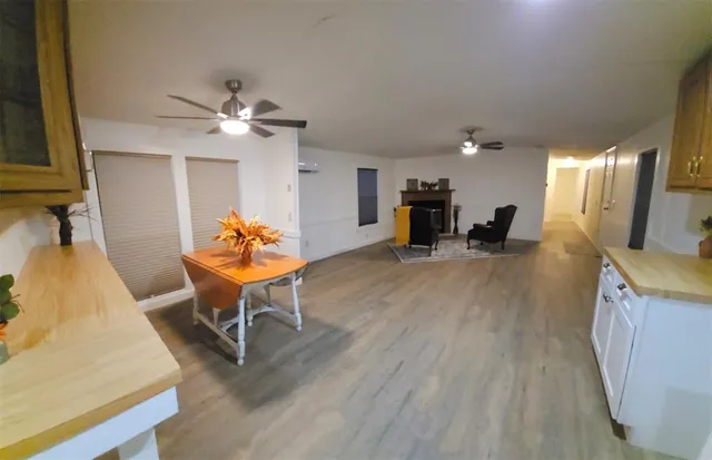 a living room with furniture and a dining room