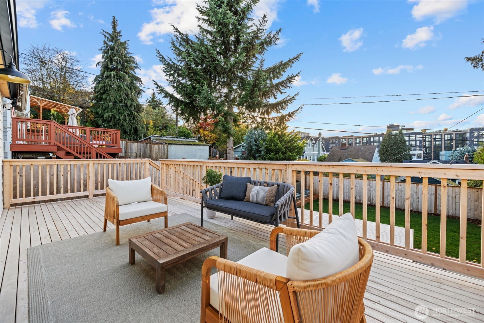 4725 37th Avenue Southwest Seattle, WA 98126 - Photo 25 of 37 a roof deck with couches and wooden fence