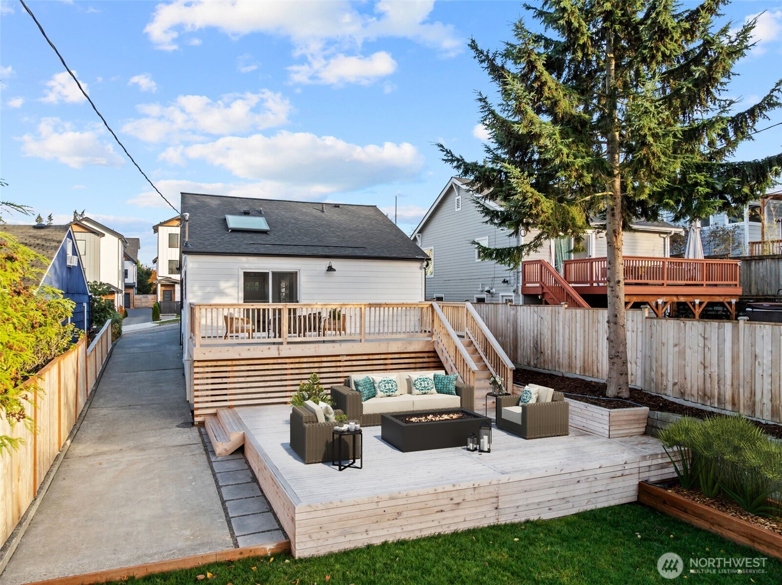 4725 37th Avenue Southwest Seattle, WA 98126 - Photo 30 of 37 a view of a house with wooden deck and furniture