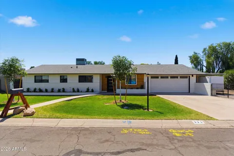 a house with swimming pool in front of it
