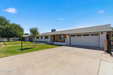 a swimming pool with yard in front of it