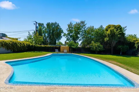 a view of a swimming pool with an outdoor space and seating area