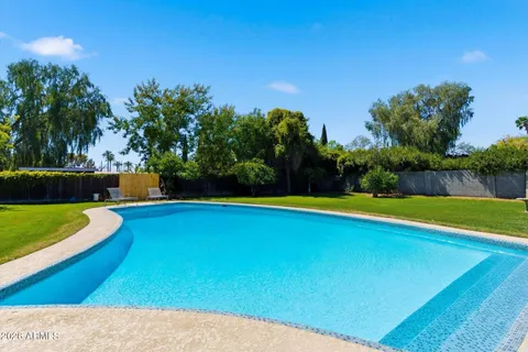 a view of a swimming pool with a yard
