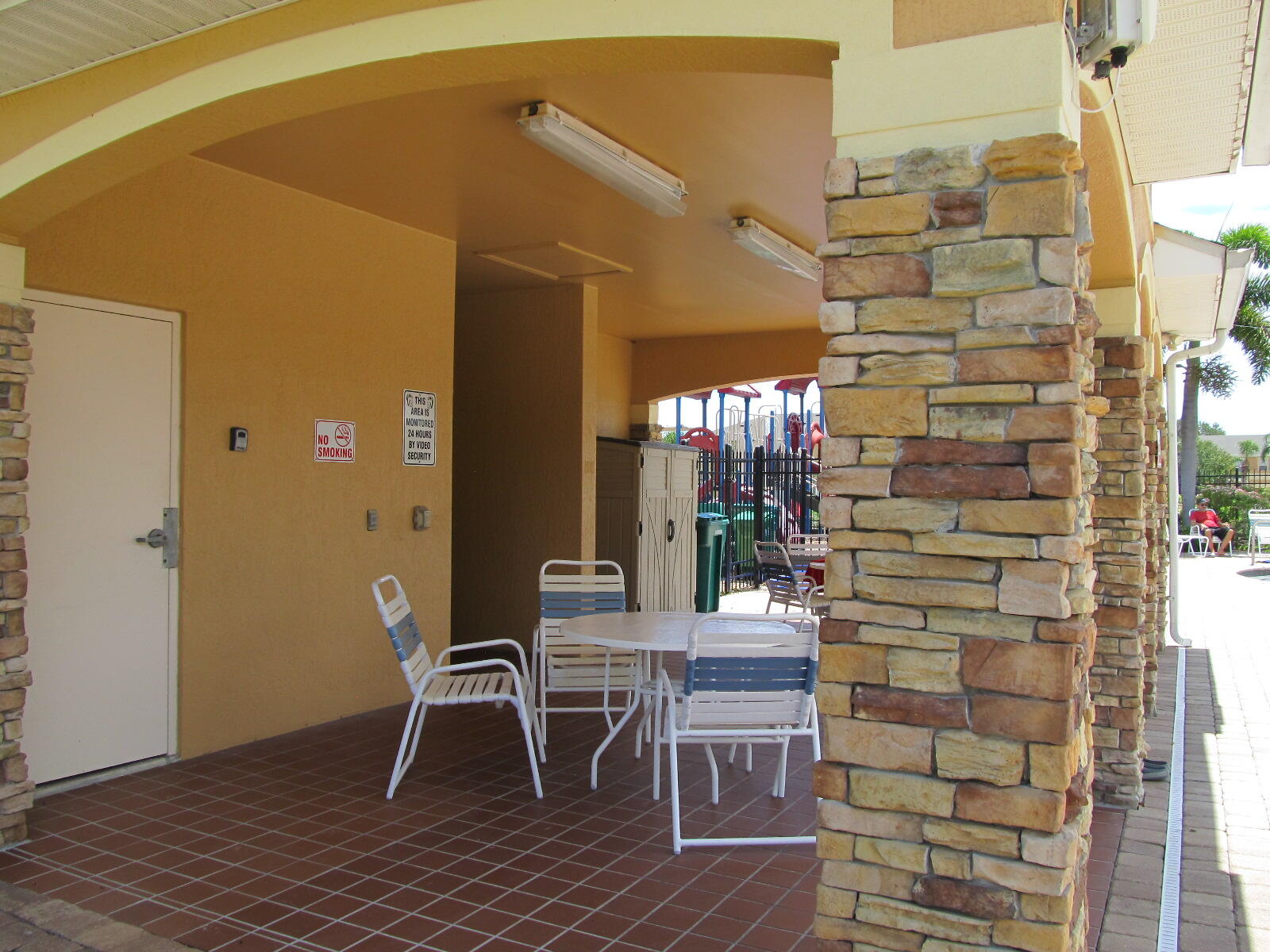 2795 Reston Street, Unit 104 Melbourne, FL 32935 - Photo 35 of 36 a patio with table and chairs