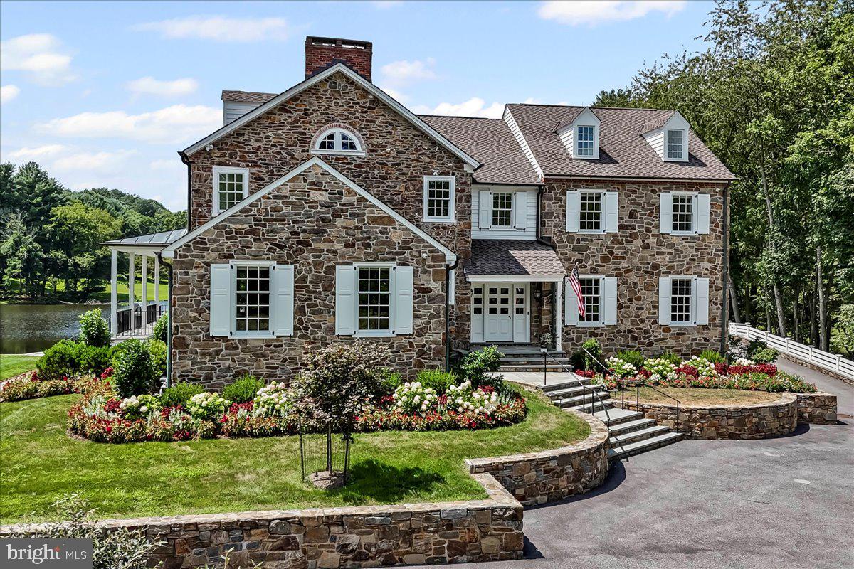 80 Heyburn Road Chadds Ford, PA 19317 - Photo 1 of 76 a front view of a house with a yard and potted plants